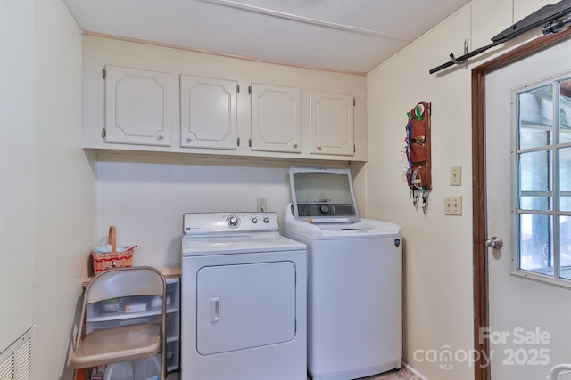 laundry area with cabinet space and independent washer and dryer