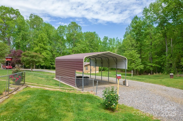 view of car parking with fence, a carport, and driveway