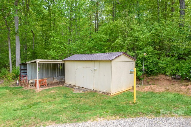 view of shed with a view of trees