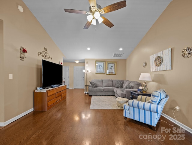 living area featuring baseboards, a ceiling fan, wood finished floors, and visible vents