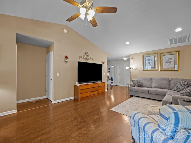 living room with a ceiling fan, visible vents, wood finished floors, baseboards, and lofted ceiling