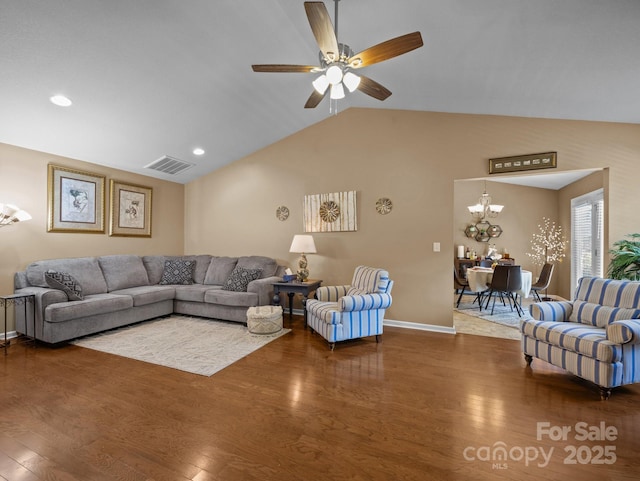 living area with visible vents, vaulted ceiling, wood finished floors, baseboards, and ceiling fan with notable chandelier