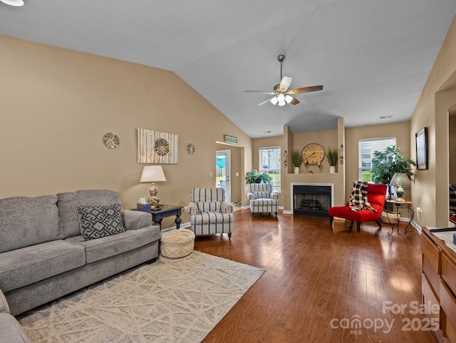 living room featuring ceiling fan, a healthy amount of sunlight, and wood finished floors