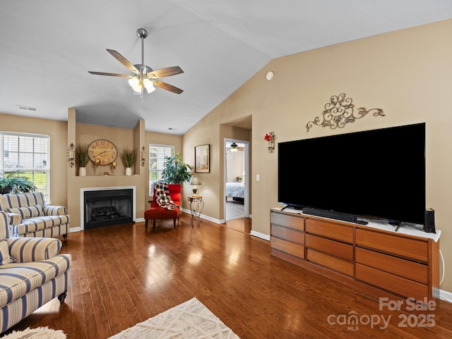 living room featuring ceiling fan, wood finished floors, and visible vents