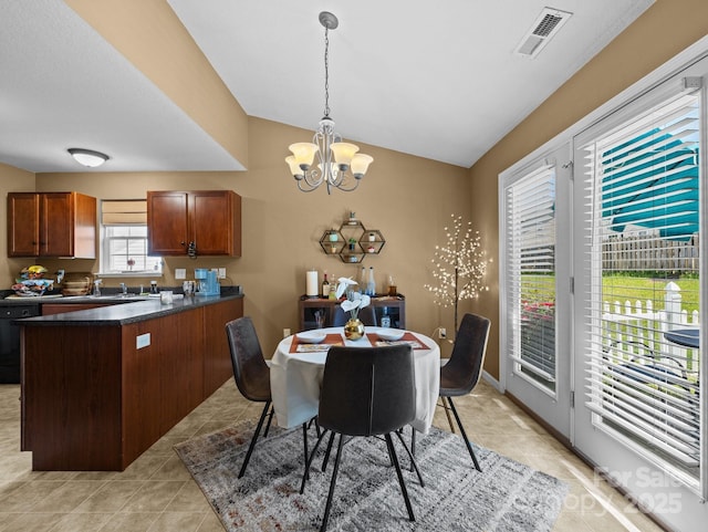 dining room with visible vents, light tile patterned floors, lofted ceiling, and a notable chandelier