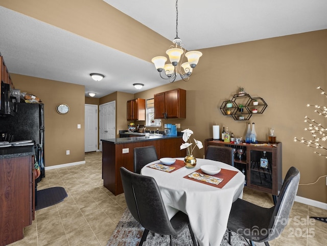 dining room with baseboards, light tile patterned flooring, and a chandelier