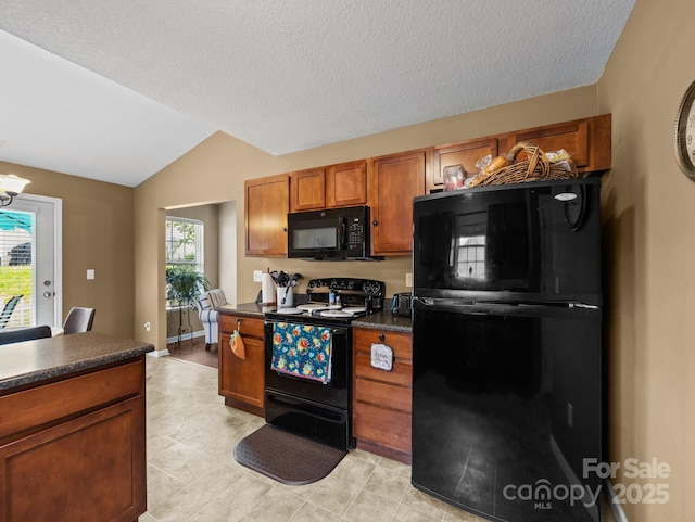 kitchen with brown cabinets, dark countertops, an inviting chandelier, vaulted ceiling, and black appliances