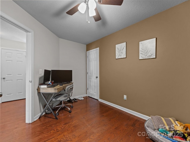 office featuring baseboards, a ceiling fan, and wood finished floors