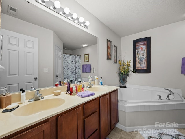 full bath with visible vents, a sink, a bath, and double vanity