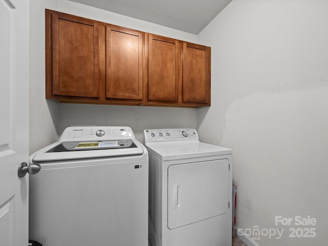 laundry room with separate washer and dryer and cabinet space