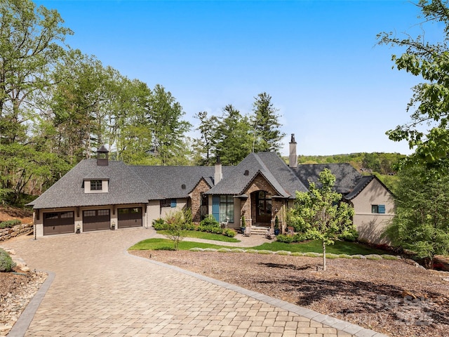 41 Bear Flower Trl, Arden, NC 28704 - view of front of property with a garage, decorative driveway, and a chimney
