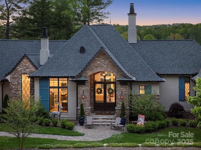 41 Bear Flower Trl, Arden, NC 28704 - french country home featuring a chimney, stone siding, stucco siding, and french doors