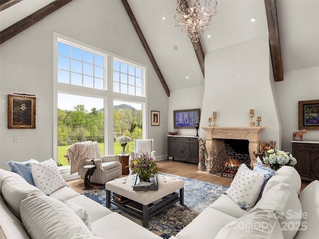 41 Bear Flower Trl, Arden, NC 28704 - living room featuring high vaulted ceiling, beam ceiling, a warm lit fireplace, wood finished floors, and a chandelier