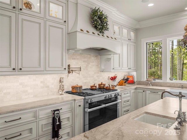 41 Bear Flower Trl, Arden, NC 28704 - kitchen with high end stainless steel range oven, premium range hood, light stone countertops, glass insert cabinets, and tasteful backsplash