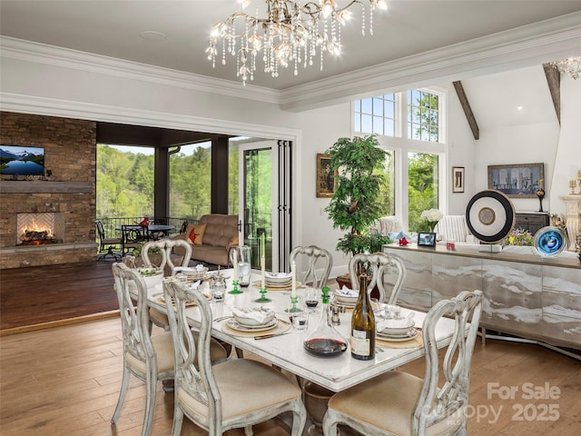 41 Bear Flower Trl, Arden, NC 28704 - dining room with hardwood / wood-style flooring, a chandelier, a fireplace, and ornamental molding
