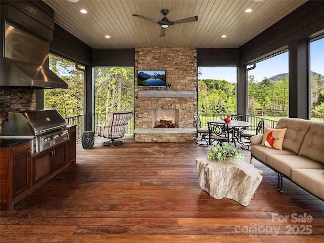 41 Bear Flower Trl, Arden, NC 28704 - wooden deck with grilling area, an outdoor living space with a fireplace, ceiling fan, and outdoor dining area