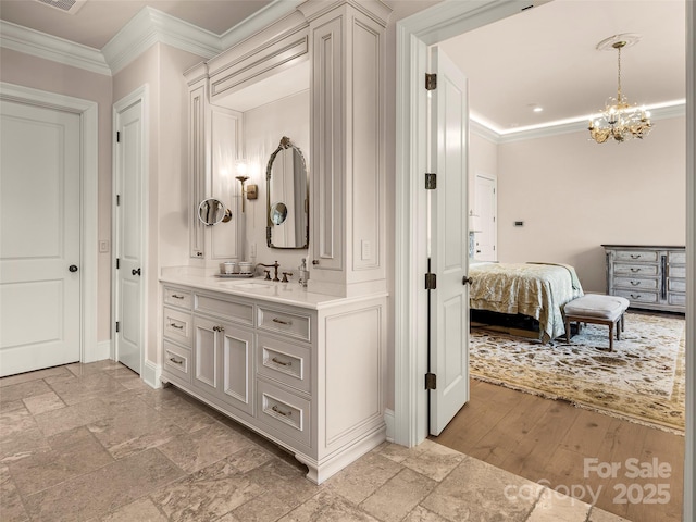 41 Bear Flower Trl, Arden, NC 28704 - bathroom featuring ornamental molding, vanity, baseboards, a chandelier, and stone tile floors