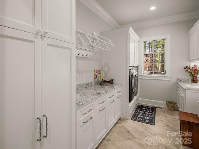 41 Bear Flower Trl, Arden, NC 28704 - washroom featuring cabinet space, ornamental molding, washer / dryer, baseboards, and recessed lighting
