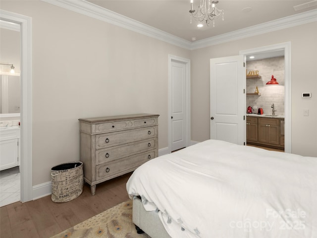 41 Bear Flower Trl, Arden, NC 28704 - bedroom with ornamental molding, ensuite bathroom, wood finished floors, a chandelier, and baseboards