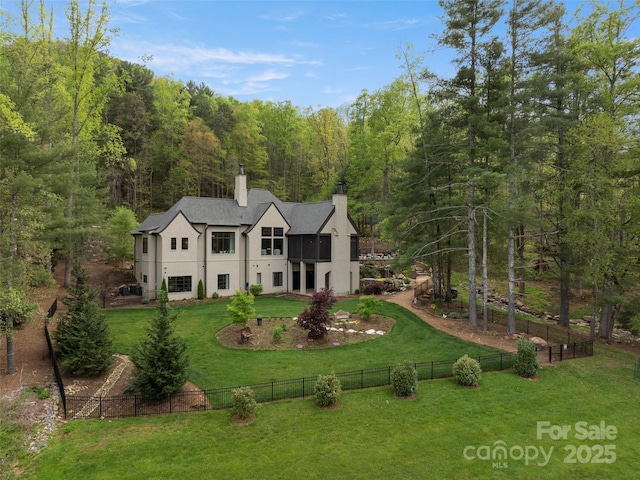 41 Bear Flower Trl, Arden, NC 28704 - view of front facade with stucco siding, a wooded view, a chimney, and a balcony