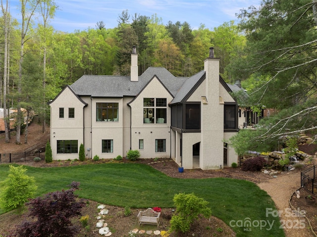 41 Bear Flower Trl, Arden, NC 28704 - back of property featuring a chimney, stucco siding, and a sunroom