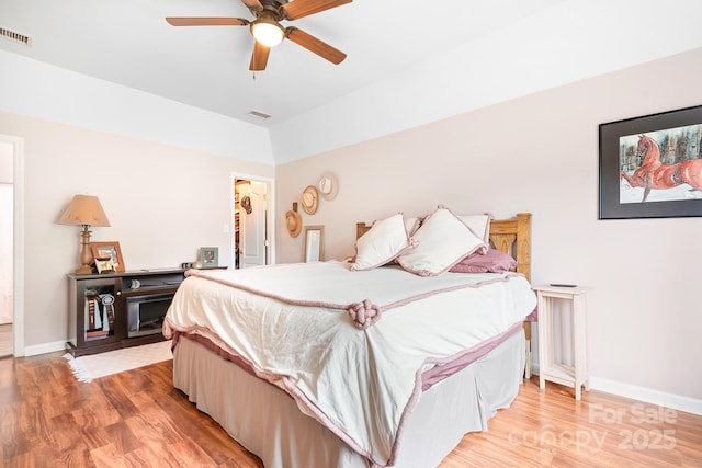 bedroom with light wood-style floors, visible vents, and baseboards