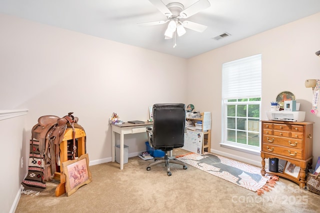 carpeted office space with a ceiling fan, visible vents, and baseboards