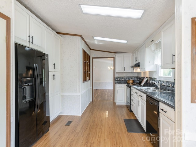 kitchen with wallpapered walls, black appliances, dark countertops, white cabinetry, and a textured ceiling