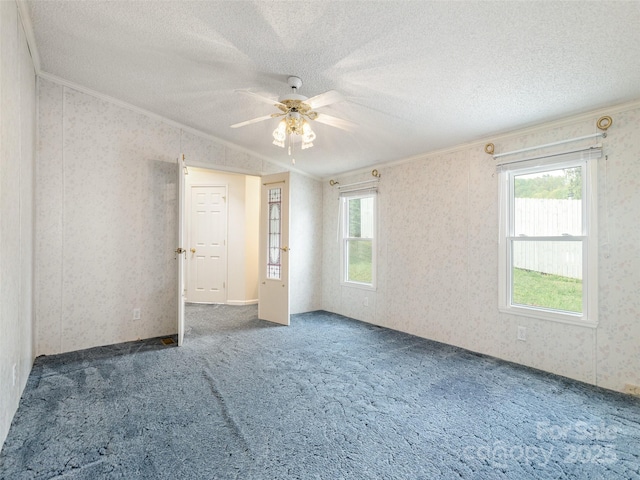 unfurnished bedroom with crown molding, carpet flooring, wallpapered walls, and multiple windows