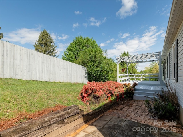 view of yard with fence, a patio area, and a pergola