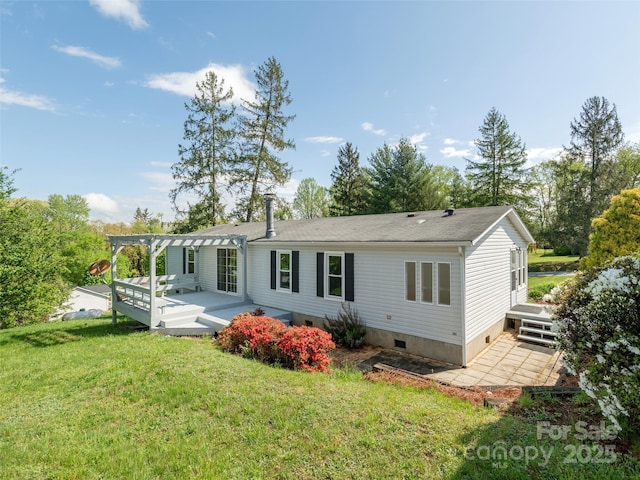 back of property with a deck, a yard, a shingled roof, crawl space, and a pergola
