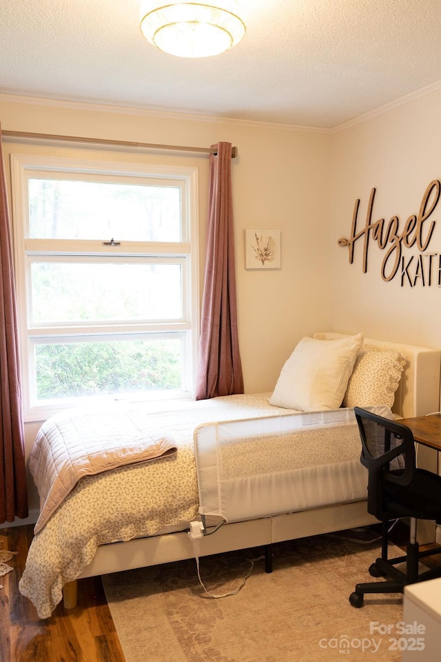 bedroom featuring crown molding and a textured ceiling