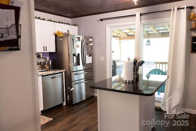kitchen featuring a healthy amount of sunlight, appliances with stainless steel finishes, dark wood-style flooring, and white cabinetry