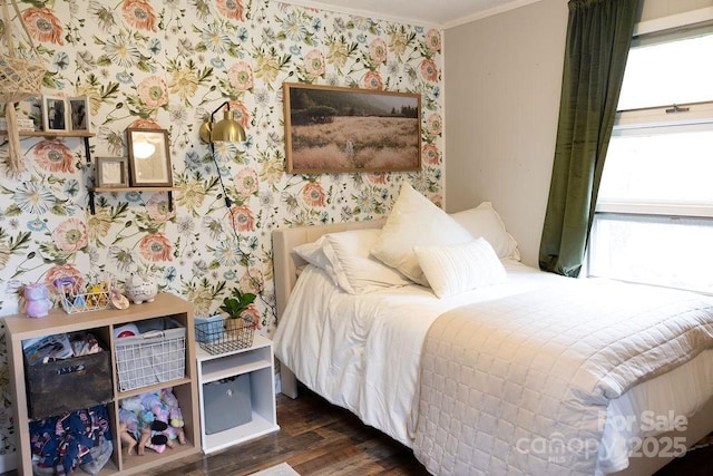 bedroom featuring dark wood-style flooring, wallpapered walls, and ornamental molding