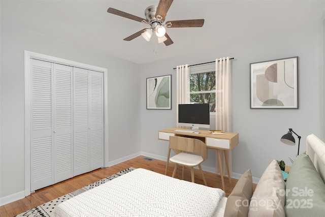 bedroom featuring baseboards, a closet, and light wood-style flooring