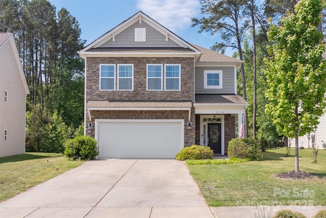 craftsman-style home featuring a front yard, driveway, and stone siding