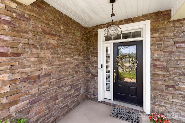 view of exterior entry with brick siding