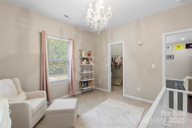 bedroom featuring a closet, baseboards, a walk in closet, light colored carpet, and a notable chandelier