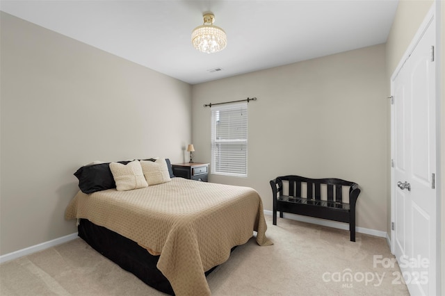 bedroom featuring baseboards, a notable chandelier, light carpet, and visible vents