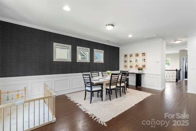 dining area with dark wood finished floors, wallpapered walls, an accent wall, a decorative wall, and recessed lighting