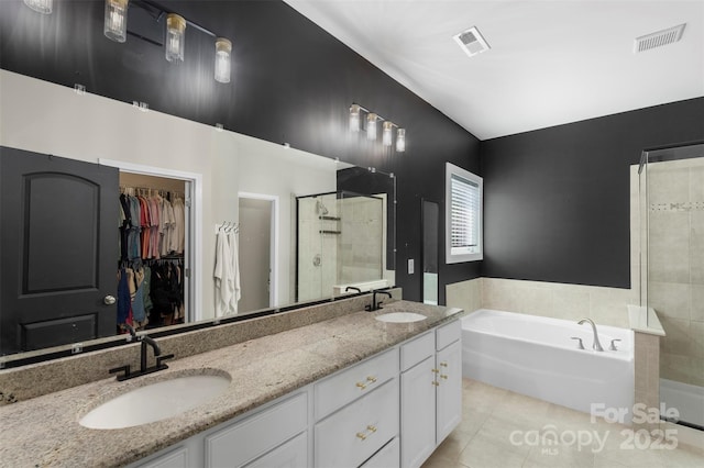 bathroom featuring visible vents, a sink, and tile patterned floors