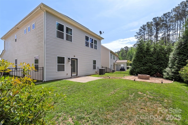 back of property with fence, central AC, a patio, a yard, and a fire pit