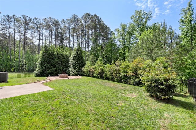 view of yard with a patio area, fence, and cooling unit