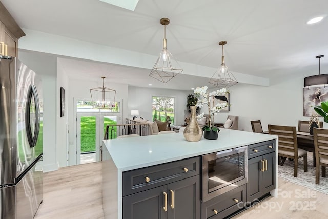 200 Kimrod Ln, Charlotte, NC 28270 - kitchen featuring appliances with stainless steel finishes, light wood-style floors, light countertops, pendant lighting, and a chandelier