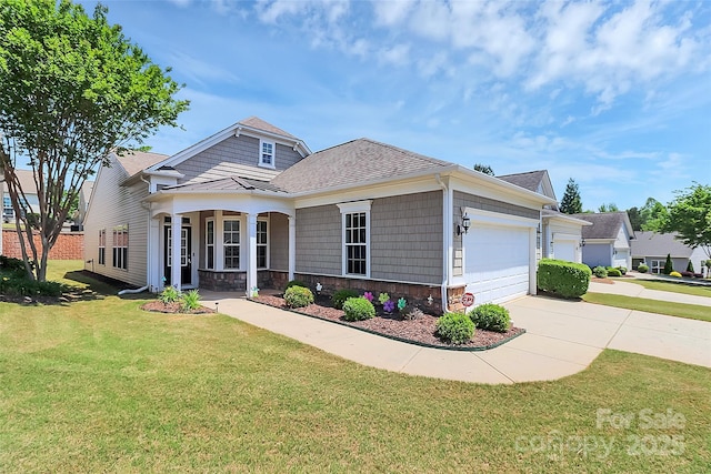 18020 Owl Ct, Indian Land, SC 29707 - craftsman house featuring driveway, a front yard, an attached garage, a shingled roof, and stone siding