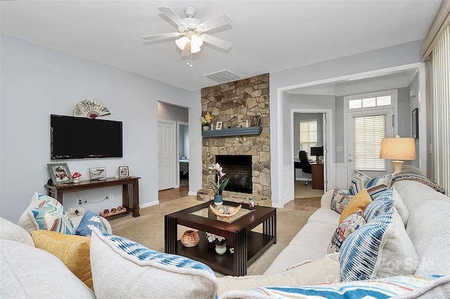 18020 Owl Ct, Indian Land, SC 29707 - living area with light carpet, a stone fireplace, a ceiling fan, baseboards, and visible vents