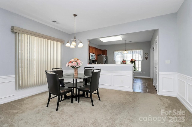 18020 Owl Ct, Indian Land, SC 29707 - dining room with visible vents, wainscoting, a decorative wall, carpet, and a notable chandelier