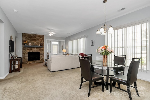 18020 Owl Ct, Indian Land, SC 29707 - dining area featuring visible vents, ceiling fan with notable chandelier, light carpet, and a stone fireplace