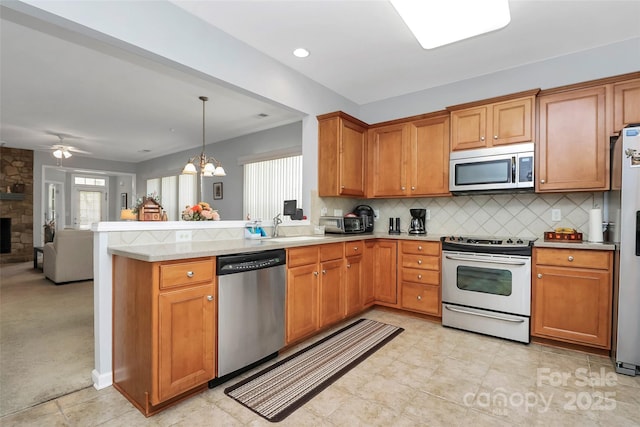 18020 Owl Ct, Indian Land, SC 29707 - kitchen featuring light countertops, a sink, a peninsula, open floor plan, and stainless steel appliances