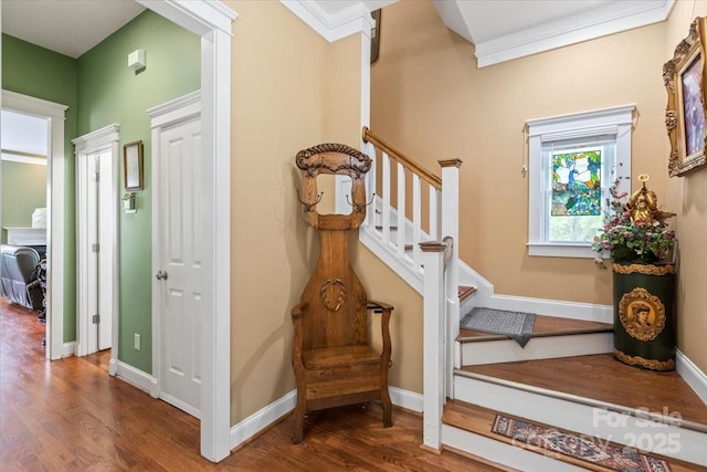 staircase with wood finished floors and baseboards